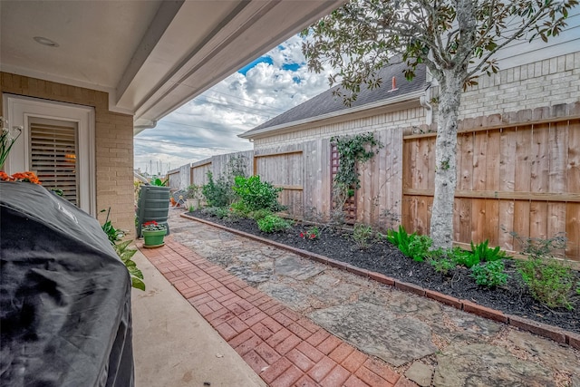 view of patio with a grill and a fenced backyard