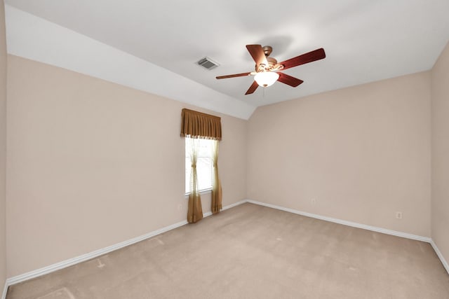 spare room featuring ceiling fan, light carpet, visible vents, and baseboards