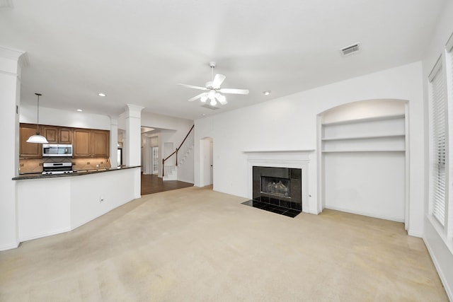 unfurnished living room featuring light carpet, a tiled fireplace, visible vents, recessed lighting, and a ceiling fan