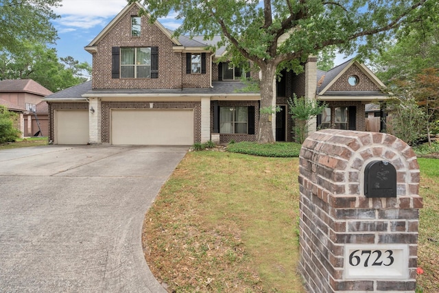 craftsman inspired home with a front lawn, brick siding, driveway, and an attached garage