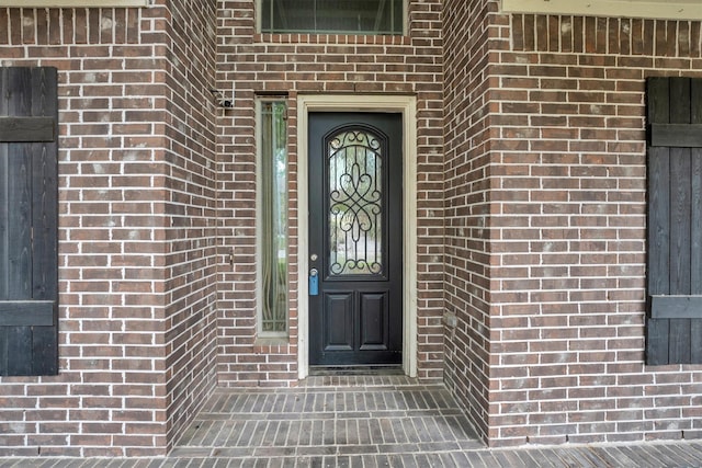 property entrance with brick siding