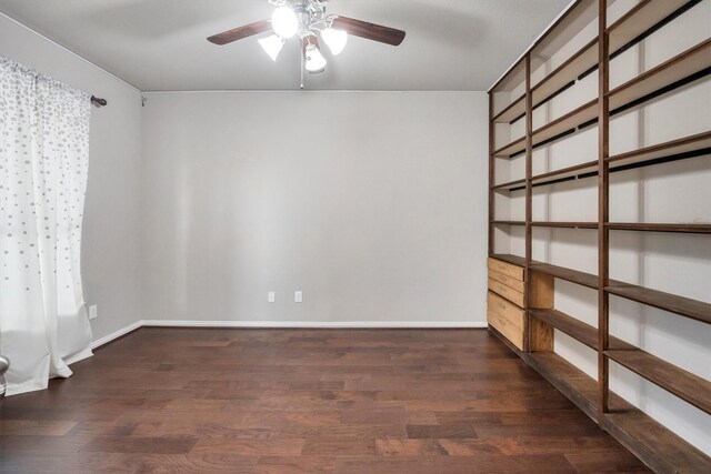 spare room with baseboards, a ceiling fan, and wood finished floors