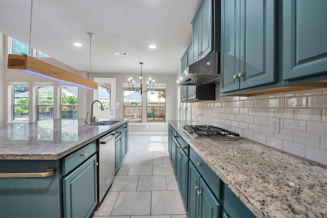 kitchen with a sink, light tile patterned floors, appliances with stainless steel finishes, backsplash, and under cabinet range hood