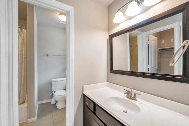 bathroom featuring toilet, vanity, tile patterned floors, and baseboards
