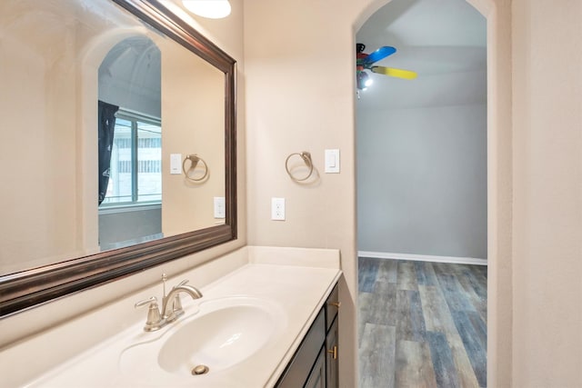 bathroom with wood finished floors, vanity, and ceiling fan