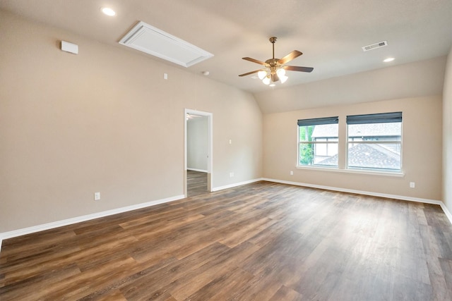 unfurnished room with attic access, visible vents, dark wood-type flooring, and ceiling fan