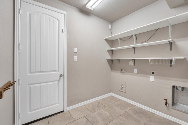 washroom featuring hookup for an electric dryer, gas dryer hookup, laundry area, and baseboards