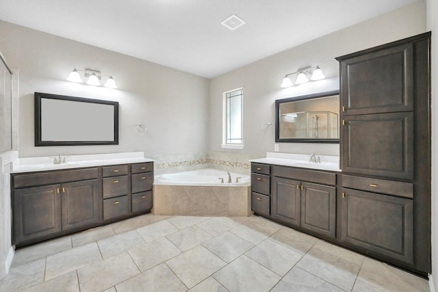 full bathroom with a shower stall, a garden tub, tile patterned floors, and a sink