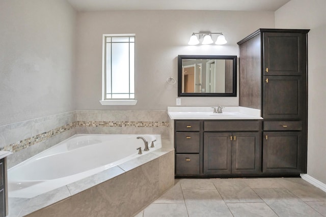 full bathroom featuring a bath, vanity, and tile patterned floors