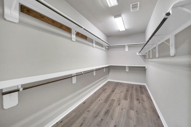 walk in closet with wood finished floors and visible vents