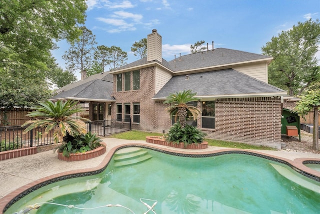 view of swimming pool with fence, a fenced in pool, and a patio