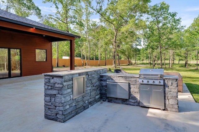 11571 Robin Ln, Conroe, TX 77303 - view of patio / terrace featuring an outdoor kitchen, grilling area, and fence