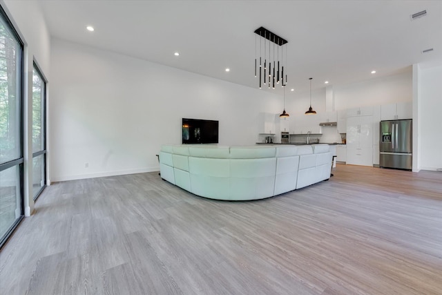 11571 Robin Ln, Conroe, TX 77303 - living room featuring baseboards, light wood finished floors, and recessed lighting