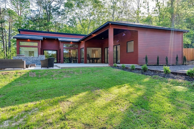 11571 Robin Ln, Conroe, TX 77303 - back of property with a lawn and a patio