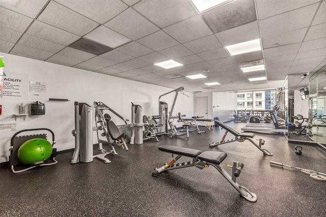 workout area with a paneled ceiling