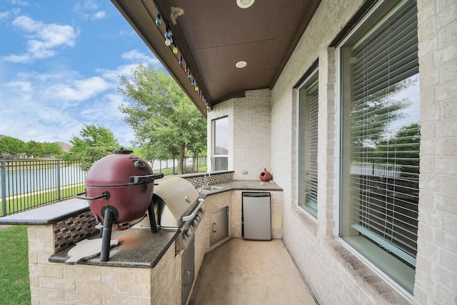 20018 Crested Peak Ln, Cypress, TX 77433 - view of patio featuring a water view and an outdoor kitchen