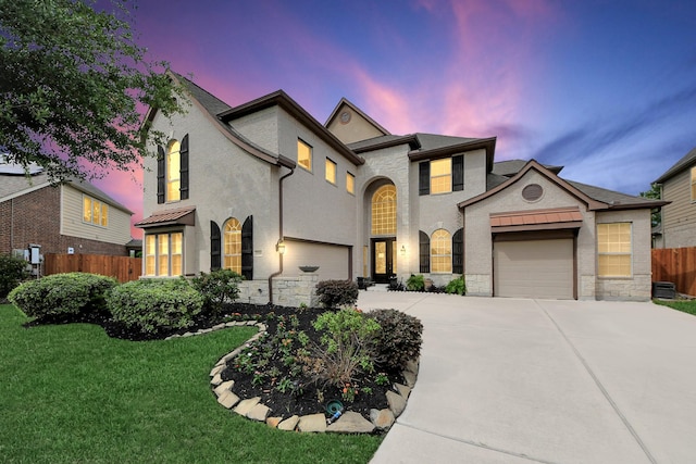 20018 Crested Peak Ln, Cypress, TX 77433 - french country inspired facade with driveway, stone siding, an attached garage, and stucco siding