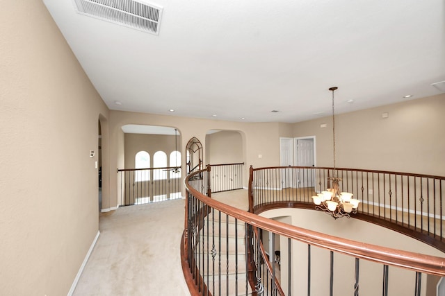 20018 Crested Peak Ln, Cypress, TX 77433 - corridor featuring a chandelier, light colored carpet, an upstairs landing, arched walkways, and recessed lighting