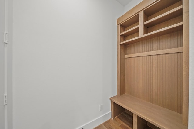 mudroom with baseboards and wood finished floors