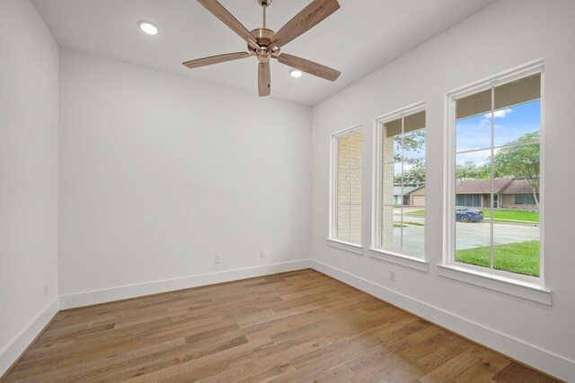 unfurnished room featuring baseboards, light wood finished floors, and ceiling fan