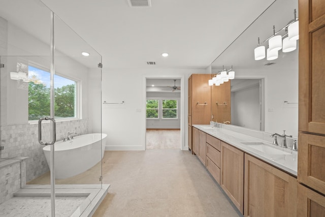 full bathroom with a sink, a soaking tub, recessed lighting, and double vanity