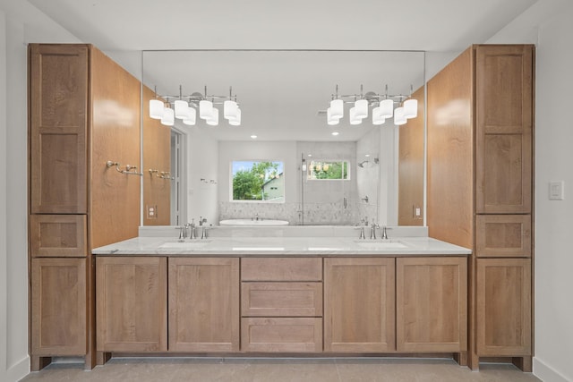full bathroom with a sink, baseboards, double vanity, and tiled shower