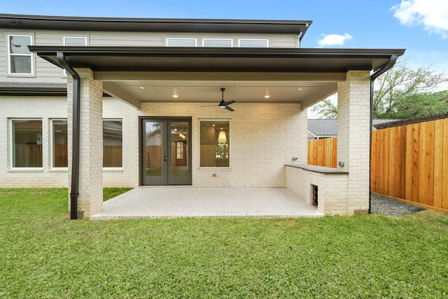 back of property with french doors, fence, a patio, and brick siding