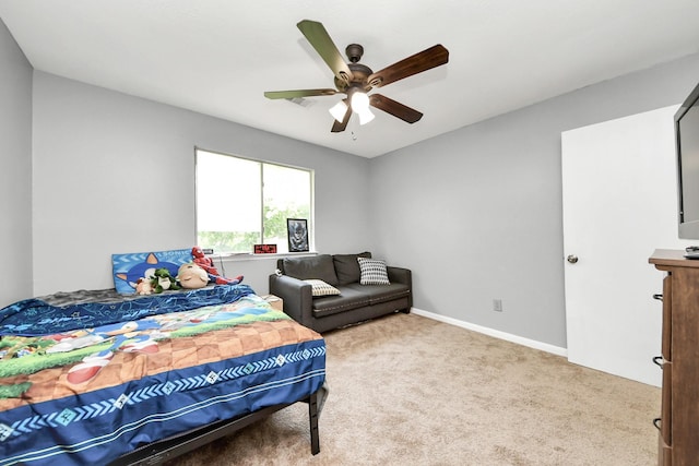 carpeted bedroom featuring baseboards and ceiling fan