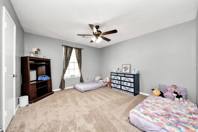 bedroom featuring ceiling fan, baseboards, and carpet flooring