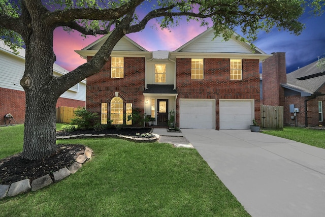 traditional-style house with fence, a front lawn, concrete driveway, an attached garage, and brick siding