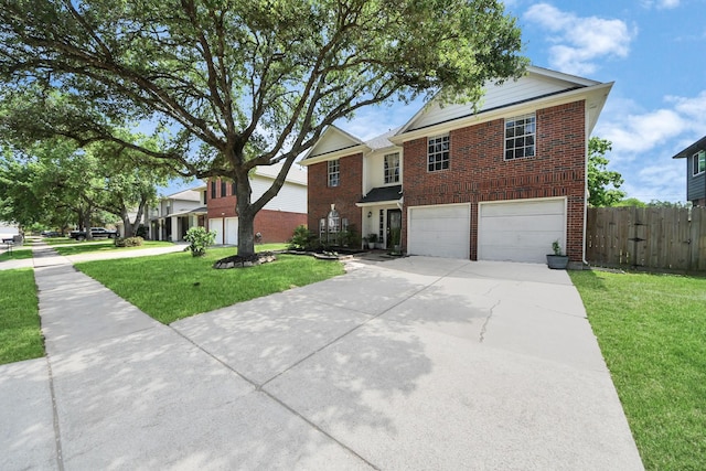 traditional-style home featuring fence, concrete driveway, an attached garage, brick siding, and a front yard