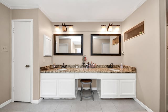 full bath with double vanity, tile patterned floors, baseboards, and a sink
