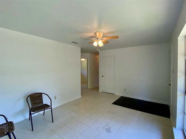 unfurnished room with baseboards, visible vents, and ceiling fan