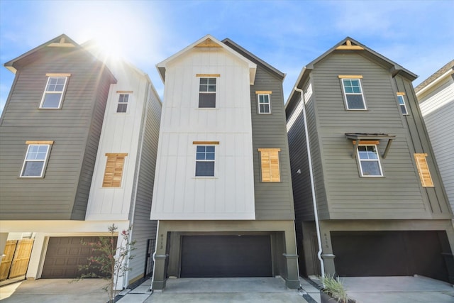 4123 De George St, Houston, TX 77009 - view of front facade with board and batten siding, an attached garage, and driveway