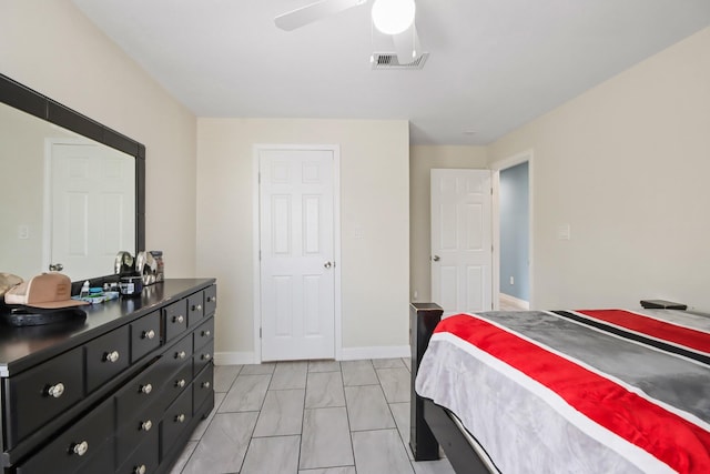 bedroom with marble finish floor, visible vents, a ceiling fan, and baseboards