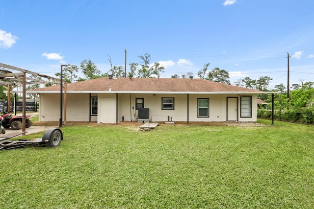 12901 Flagstaff Ln, Houston, TX 77049 - back of house featuring a yard, central AC, and a shingled roof