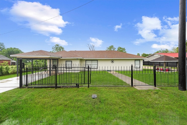 rear view of house with a lawn, fence private yard, and stucco siding