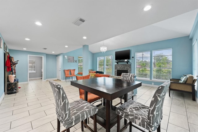 dining space featuring recessed lighting, a stone fireplace, visible vents, and baseboards