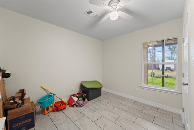 playroom featuring baseboards, visible vents, and ceiling fan