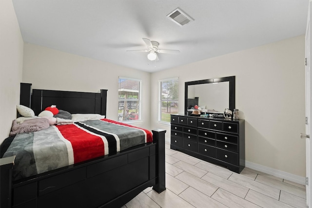 bedroom with visible vents, a ceiling fan, and baseboards
