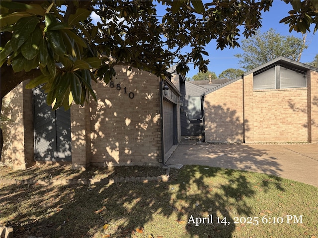view of side of home featuring brick siding