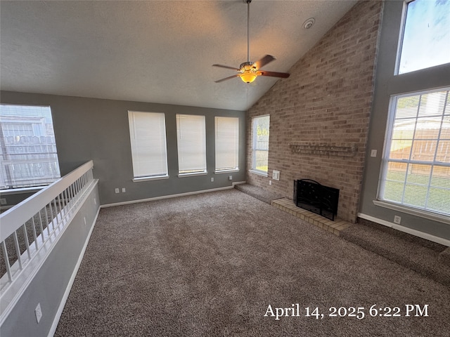 unfurnished living room with vaulted ceiling, a ceiling fan, carpet flooring, and plenty of natural light