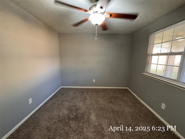 carpeted spare room featuring baseboards, a ceiling fan, and a textured ceiling