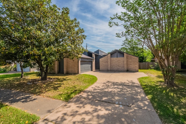 8810 Enchanted Forest Dr, Houston, TX 77088 - mid-century modern home featuring brick siding, fence, a front yard, and a detached garage