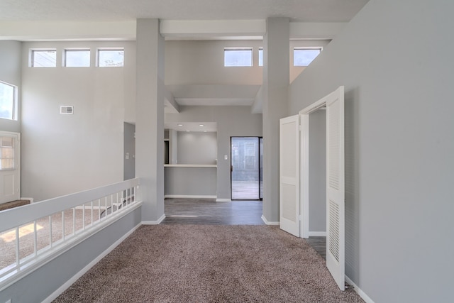 8810 Enchanted Forest Dr, Houston, TX 77088 - hall with baseboards, a high ceiling, carpet, and visible vents