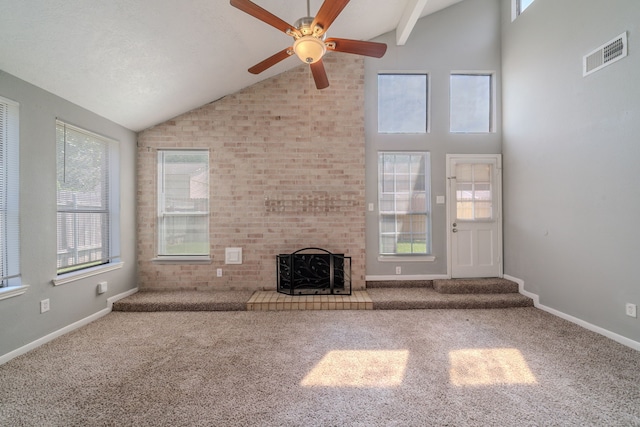 8810 Enchanted Forest Dr, Houston, TX 77088 - unfurnished living room with visible vents, carpet floors, a fireplace, ceiling fan, and vaulted ceiling with beams