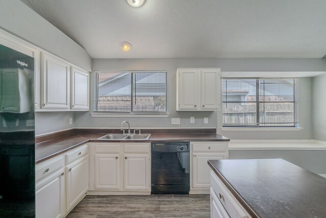 8810 Enchanted Forest Dr, Houston, TX 77088 - kitchen with wood finished floors, dark countertops, white cabinetry, a sink, and black appliances