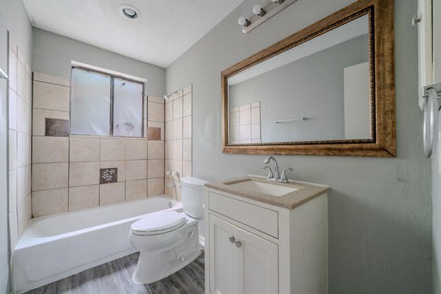 8810 Enchanted Forest Dr, Houston, TX 77088 - bathroom featuring vanity, bathtub / shower combination, toilet, and wood finished floors