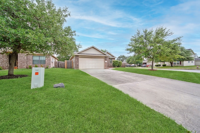 view of front of house with concrete driveway, an attached garage, fence, a front yard, and brick siding