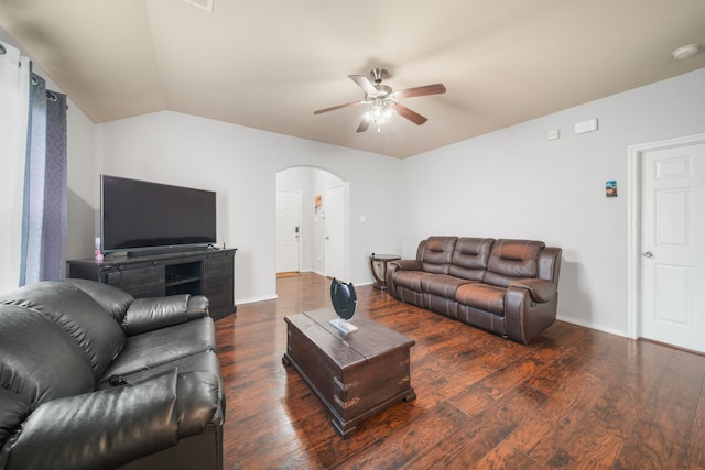 living room featuring arched walkways, vaulted ceiling, wood finished floors, and ceiling fan